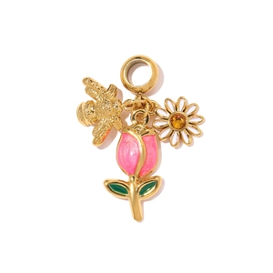 Detail view of gold circular pendant featuring enamel tulip, daisy and a bee charm