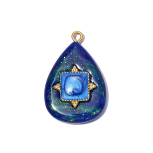 Detailed view of teardrop resin pendant with galaxy texture and gold metal ring