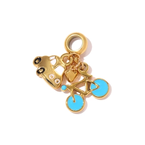 Detail of gold charms featuring a white car, blue-wheeled bicycle and heart pendant