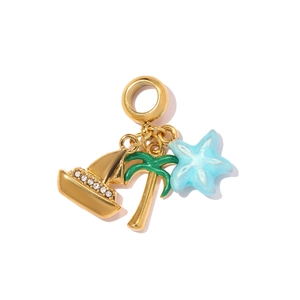 Detailed macro of gold nautical pendants with palm tree, starfish, and sailboat charms