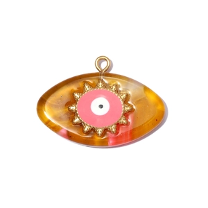 Detailed view of Turkish evil eye resin pendant with golden sunburst metal frame