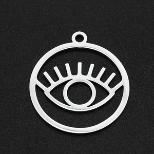 Detailed macro shot of silver stainless steel evil eye pendant with geometric hollow design