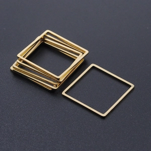 Close-up of minimalist golden square stainless steel frames for DIY jewelry making