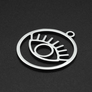 Detail of silver stainless steel evil eye pendant with long lashes for jewelry making