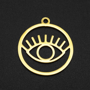 Macro view of gold stainless steel hollow Evil Eye pendant with eyelashes detail