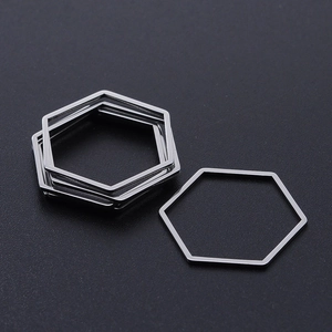 Macro shot of silver hexagon stainless steel geometric pendants for DIY jewelry making