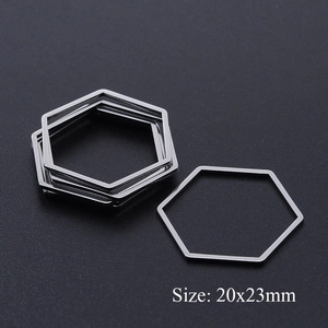 Macro view of 20x23mm hexagon stainless steel DIY jewelry pendants on black background