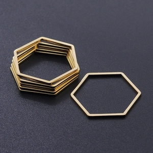 Macro detail of hexagonal gold titanium steel DIY jewelry links for pendant making