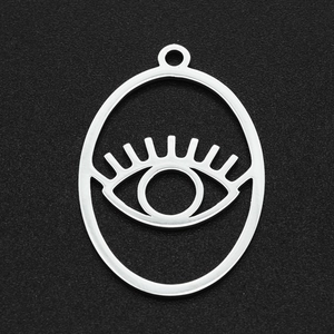 Macro view of stainless steel hollow evil eye pendant with detailed eyelash texture