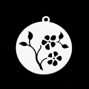Macro shot of circular hollow flower pendant made of polished stainless steel for DIY jewelry