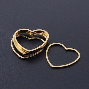 Close-up of golden stainless steel heart frames for DIY jewelry making accessories