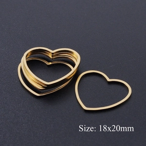 Close-up of golden heart-shaped stainless steel DIY jewelry pendants sized 18x20mm
