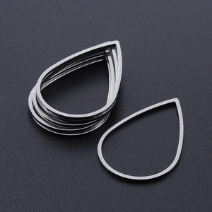 Detailed macro view of silver teardrop hollow stainless steel jewelry frames for DIY crafts