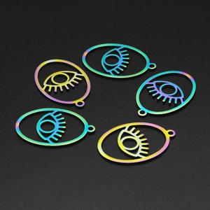 Macro detail of five rainbow plated stainless steel evil eye charms with eyelashes