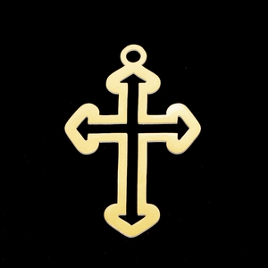 Detail shot of golden stainless steel cross pendant with arrow edges and cutout center