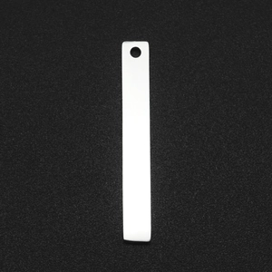Close-up of a polished stainless steel rectangular tag pendant with top hole