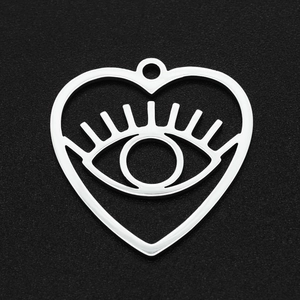 Detailed macro view of heart-shaped stainless steel evil eye pendant with hollow design