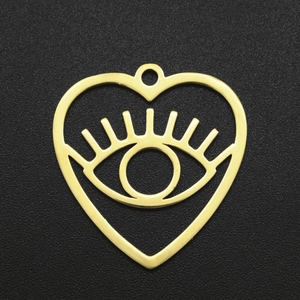 Macro shot of a golden heart-shaped evil eye pendant made of polished stainless steel
