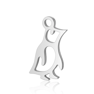 Macro shot of silver stainless steel penguin pendant with hollow design and smooth finish