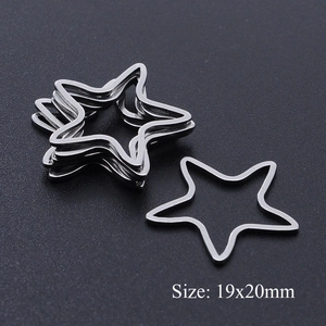 Macro detail of star-shaped stainless steel jewelry link 19x20mm on grey matte background