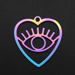 Macro shot of iridescent heart-shaped evil eye pendant in polished stainless steel