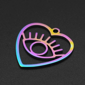 Macro detail of rainbow plated stainless steel evil eye heart pendant with cut-out design