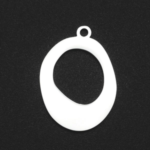 Close-up of white asymmetric oval pendant with ring connector for DIY jewelry making