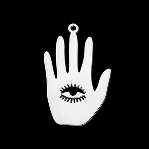Macro view of silver stainless steel Hamsa hand pendant with cutout eye detail
