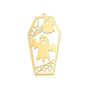 Macro detail of golden stainless steel coffin pendant with ghost and spider web cutouts