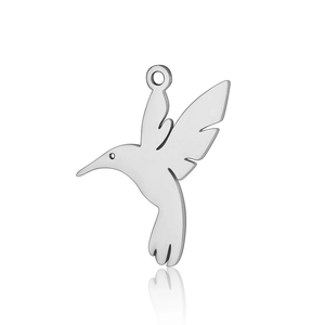 Macro detail of hummingbird charm pendant in silver stainless steel with hollow design