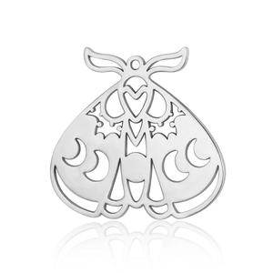 Macro shot of silver moth pendant featuring symmetrical moon phase cutout patterns