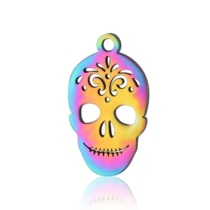 Macro shot of colorful rainbow skull pendant in stainless steel with hollow patterns