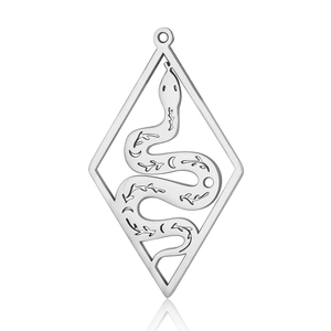 Macro detail of stainless steel snake pendant featuring moon and star engravings