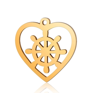 Macro shot of gold stainless steel heart pendant with internal nautical helm ship wheel