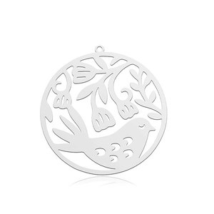 Macro detail of bird and floral cutout pattern on silver stainless steel pendant