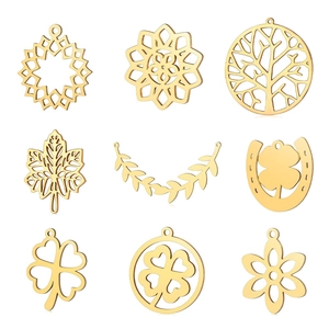Detailed view of nine gold-plated stainless steel leaf and flower charms for DIY jewelry
