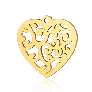 Detailed macro view of a gold heart pendant with intricate bohemian filigree patterns