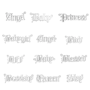 Macro view of stainless steel Gothic word pendants like Queen and Angel for DIY jewelry