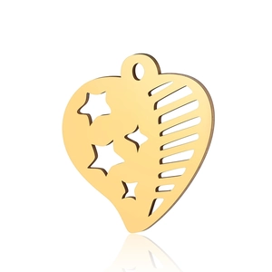 Detail of golden stainless steel heart pendant with star and line cutouts
