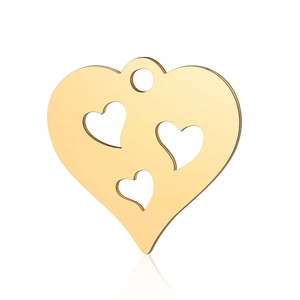 Detailed macro view of a polished golden heart charm with three hollow heart cutouts