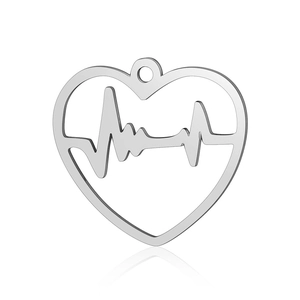 Macro shot of polished stainless steel heart pendant with cutout heartbeat pattern detail