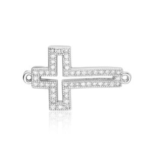 Detailed view of a silver-tone cross jewelry connector set with white zircon stones