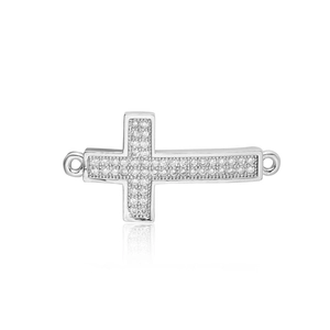 Macro detail of silver cross jewelry connector with white pavé-set zircon stones