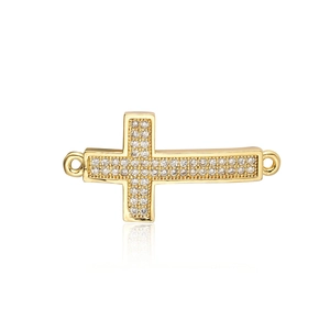 Detailed close-up of golden cross connector with zircon stones and dual side rings