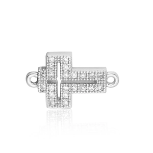 Close-up of a silver cross connector with pavé-set zircons and dual loops for DIY jewelry