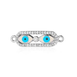 Macro shot of silver evil eye jewelry connector with blue enamel and sparkling zircons