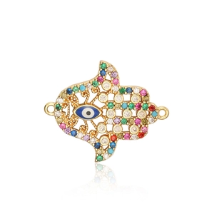 Macro view of gold Hamsa hand connector charm with colorful zircon and evil eye detail