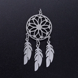 Macro detail of stainless steel lotus dreamcatcher pendant with three delicate metal feathers