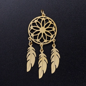 Detailed macro view of a golden dreamcatcher pendant featuring delicate metal feathers