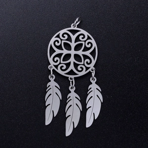 Detailed macro view of silver stainless steel lotus dreamcatcher pendant with three feathers